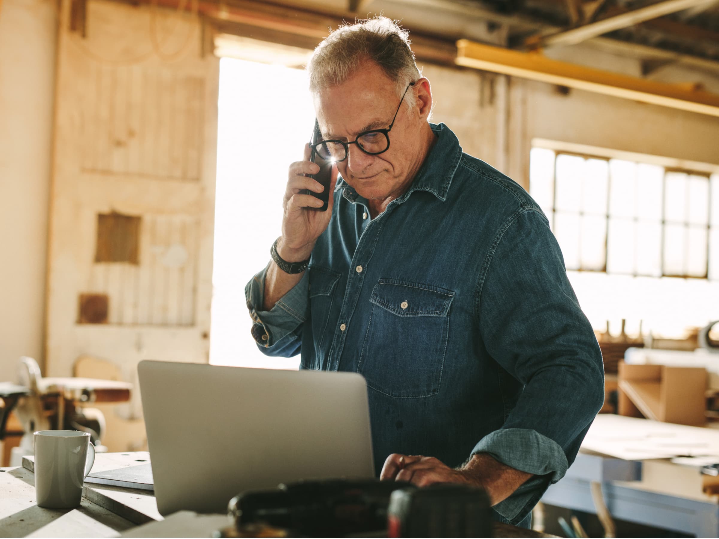 An older man on the phone as he makes a retirement plan.