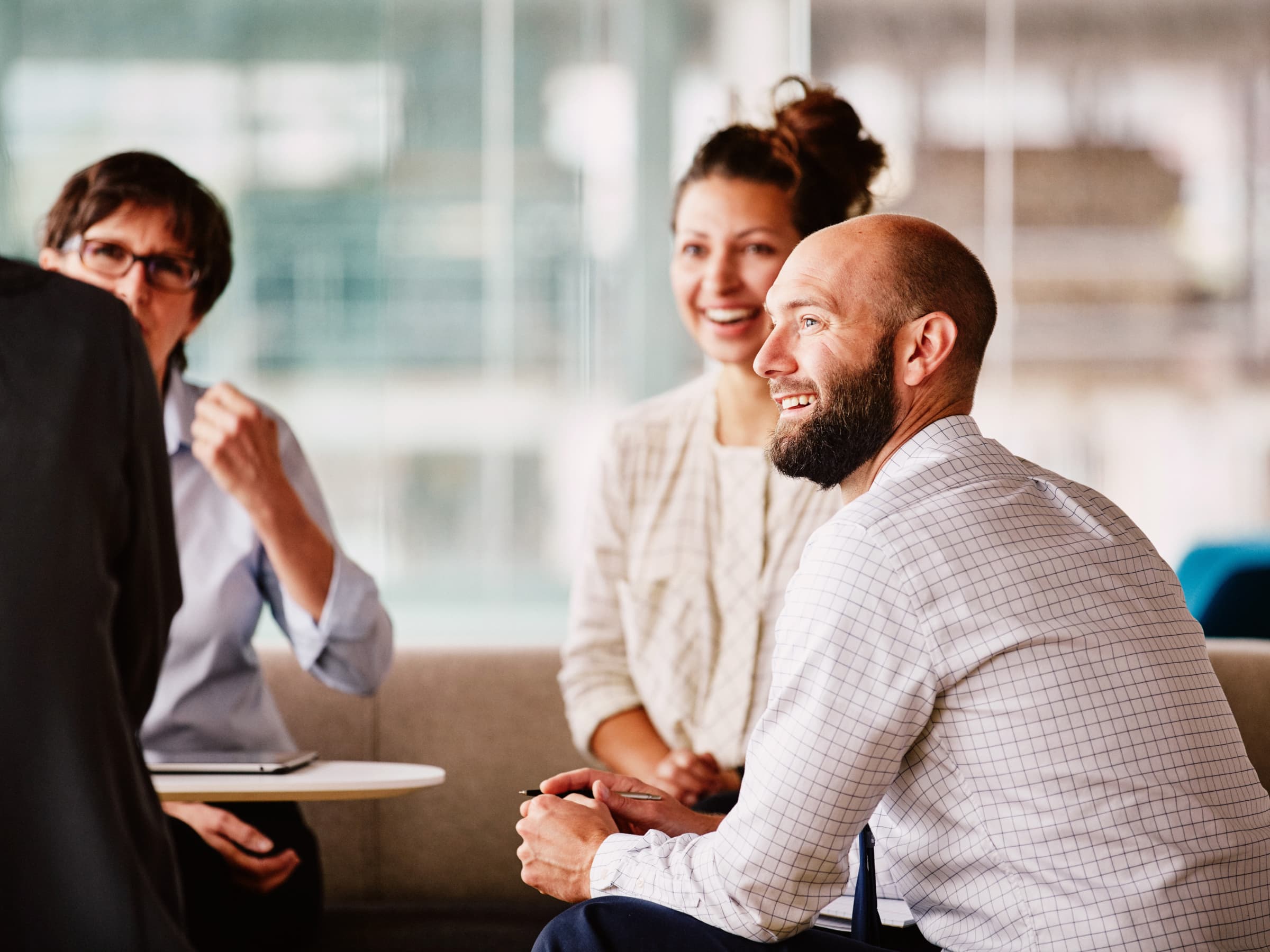 Our corporate team smiling while collaborating on a task.