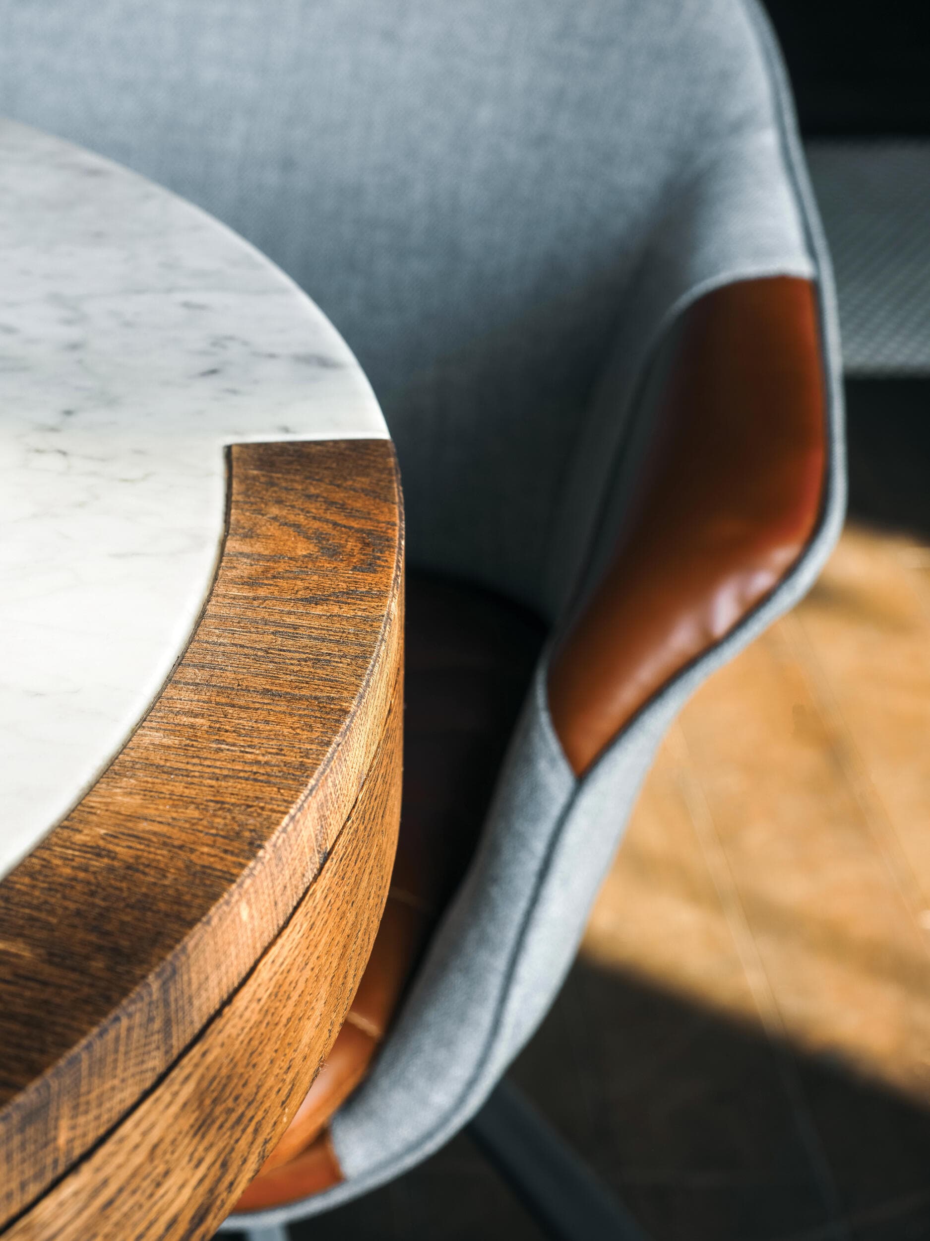 A photo of a chair tucked into a boardroom table.